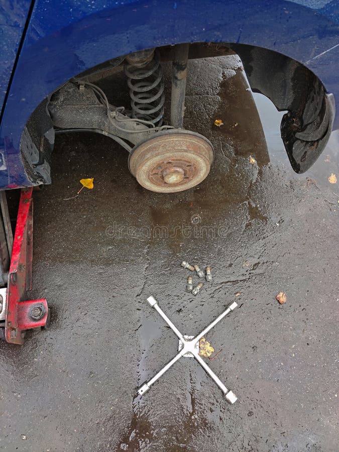 Changing a Wheel on a Car Jack at a Car Service Station Stock Photo