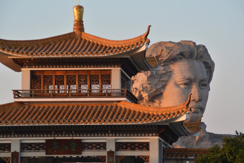 Orange Island park in Hunan Changsha, the head statue of chairman Mao Zedong view behind Chinese old house. Orange Island park in Hunan Changsha, the head statue of chairman Mao Zedong view behind Chinese old house