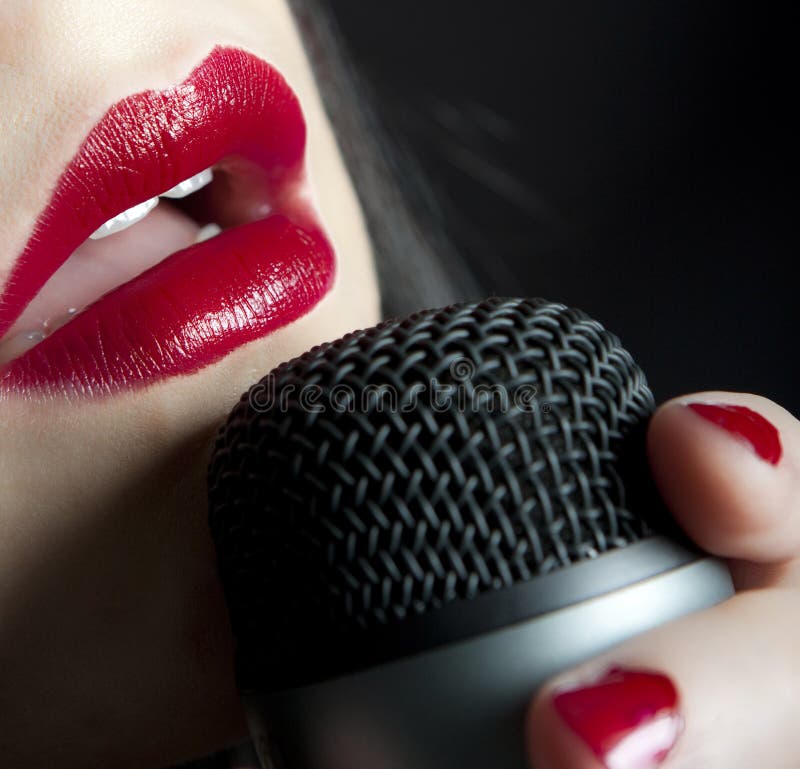 Woman red lips singing music in microphone. Woman red lips singing music in microphone