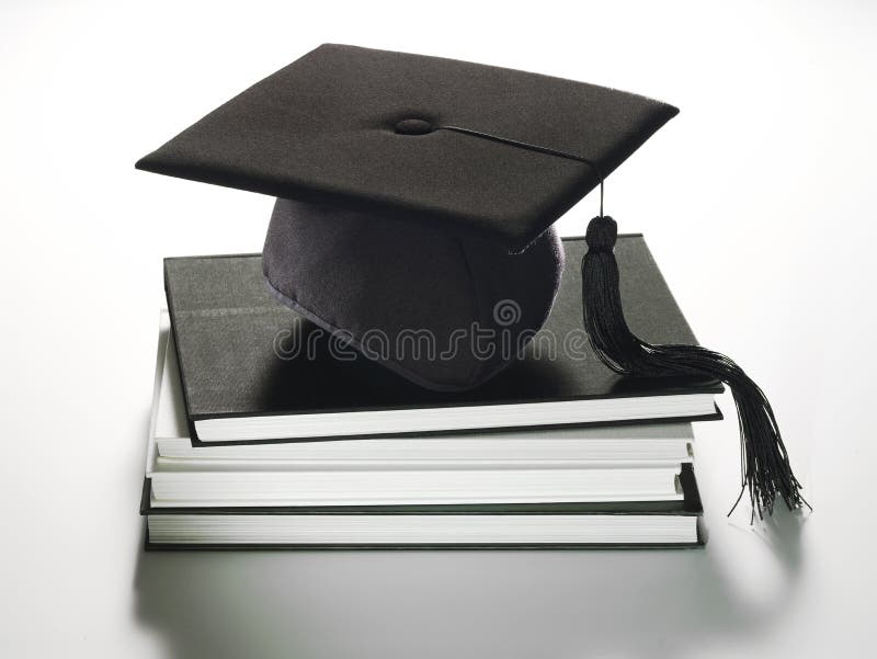 A graduation hat sitting on a stack of books. A graduation hat sitting on a stack of books.