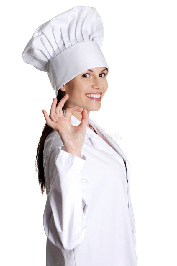 Chapéu do cozinheiro chefe desgastando feliz, sorrindo da mulher nova. foto de stock royalty free Chapéu do cozinheiro chefe desgastando feliz, sorrindo da mulher nova. foto de stock royalty free
