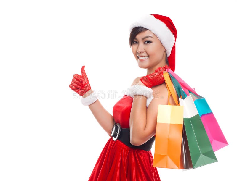 Chapéu vestindo de pensamento e guardar de Santa da mulher da compra do Natal fotografia de stock royalty free Chapéu vestindo de pensamento e guardar de Santa da mulher da compra do Natal fotografia de stock royalty free