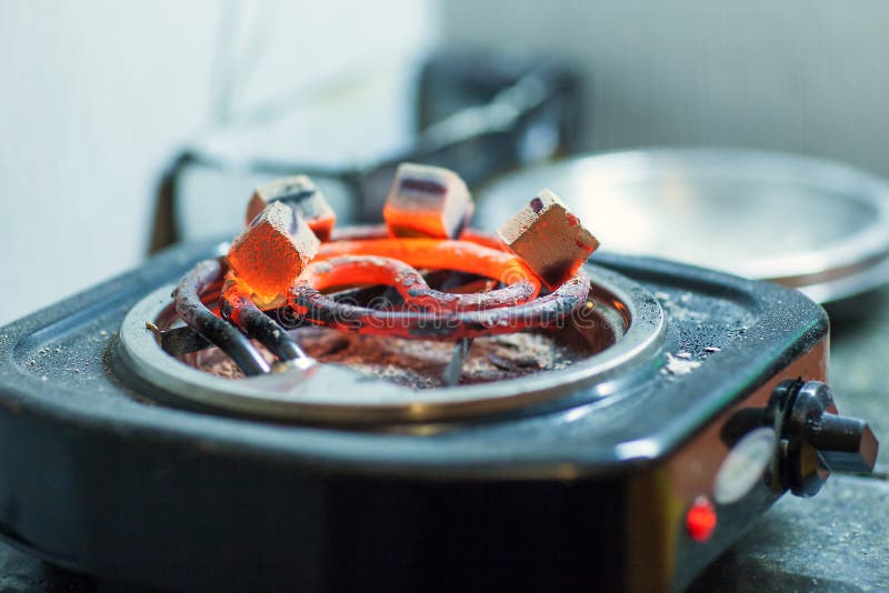 Coal for hookah warm-up on the grill. Coal for hookah warm-up on the grill.