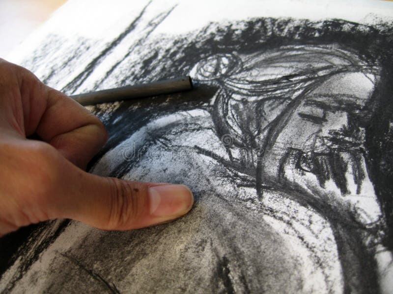 A thumb smudging the charcoal on the sketch pad. The sketch is of the photographerâ€™s original artwork. A thumb smudging the charcoal on the sketch pad. The sketch is of the photographerâ€™s original artwork