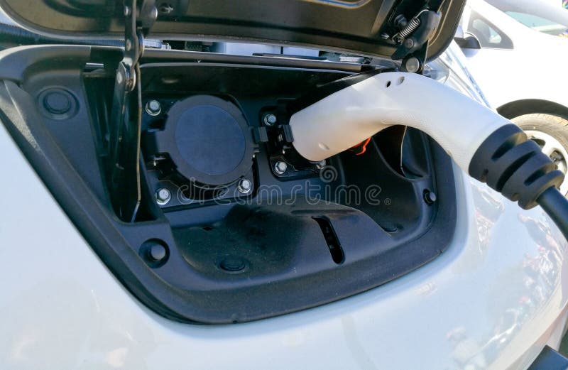 Charging adapter of electronic vehicle engine white car royalty free stock photography Charging adapter of electronic vehicle engine white car royalty free stock photography