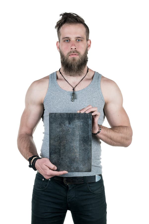 A charismatic man with a beard holds an empty sign for a copy space, on a white isolated background. Vertical frame royalty free stock photography