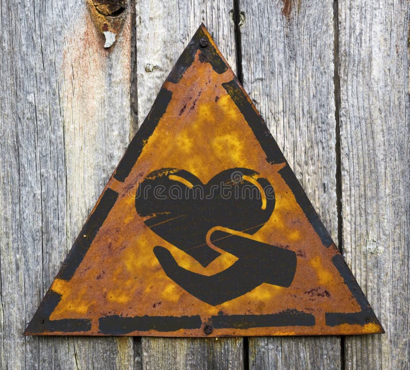 Charity Concept on Weathered Warning Sign.