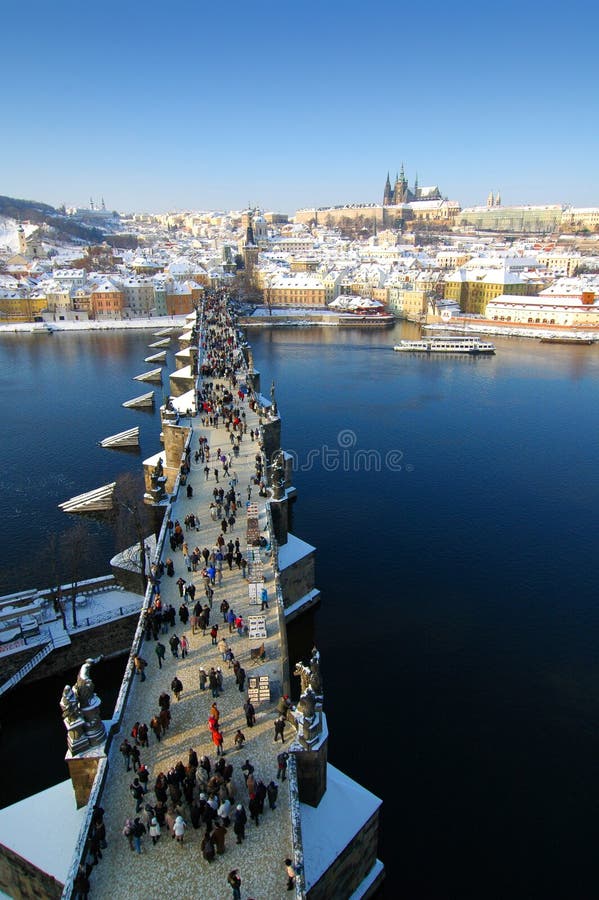 Charles bridge. View over the Charles bridge towards the castle, in Prague. Shot from the Powder tower. The bridge is full of tourists royalty free stock photos Charles bridge. View over the Charles bridge towards the castle, in Prague. Shot from the Powder tower. The bridge is full of tourists royalty free stock photos