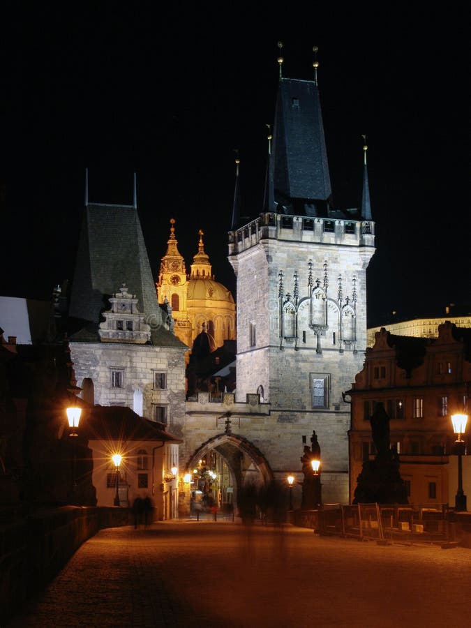 Medieval Charles Bridge in Prague with St. Nicholas' Cathedral