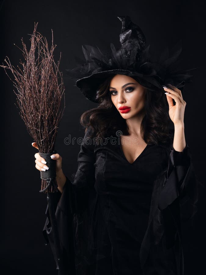 Charming halloween witch with broom over black background, woman beauty portrait, artistic make-up and costume. Charming halloween witch with broom over black background, woman beauty portrait, artistic make-up and costume