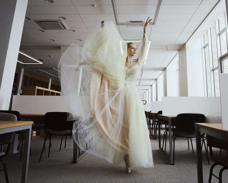 charming ballerina went to the library to choose a new book during a break showing your stretching and flexibility