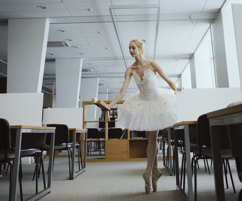 charming ballerina went to the library to choose a new book during a break showing your stretching and flexibility