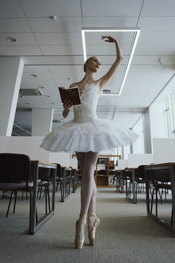 charming ballerina went to the library to choose a new book during a break showing your stretching and flexibility