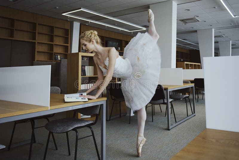 charming ballerina went to the library to choose a new book during a break showing your stretching and flexibility