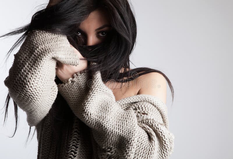 Charming brunette hiding her face by hair