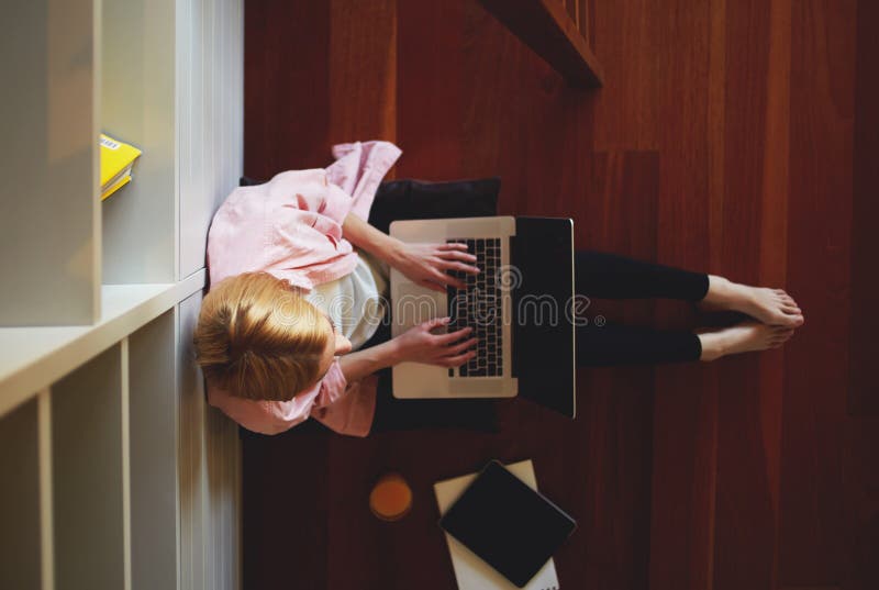 Charming business woman working from home while having breakfast