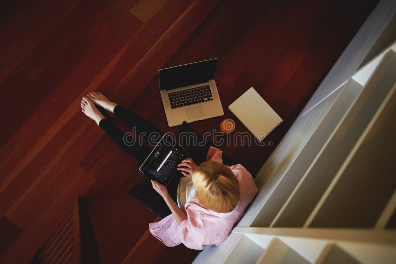 Charming business woman working from home while having breakfast