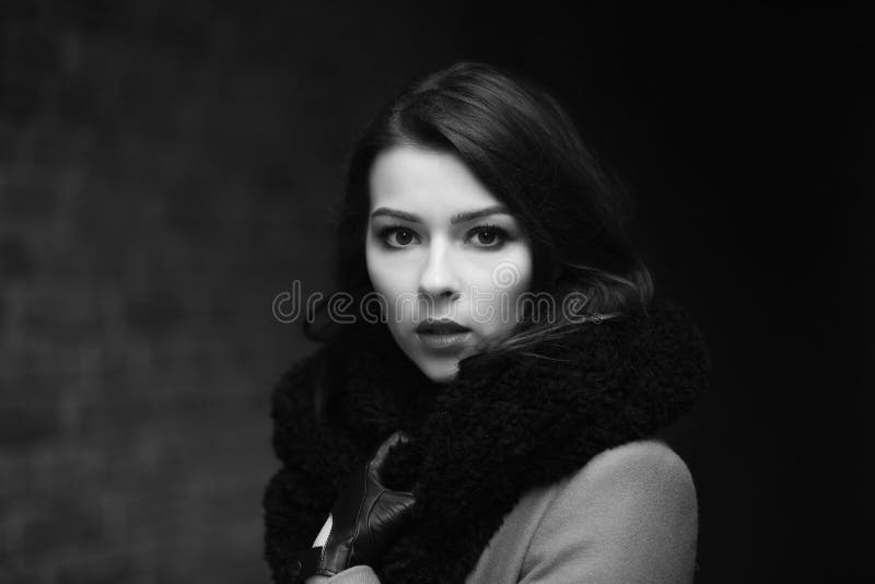Charming fashion female modell in a coat stock photos Charming fashion female modell in a coat stock photos