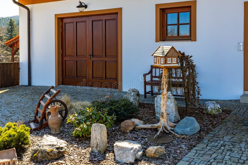 Charming garden with wooden birdhouse and rustic decor elements stock image