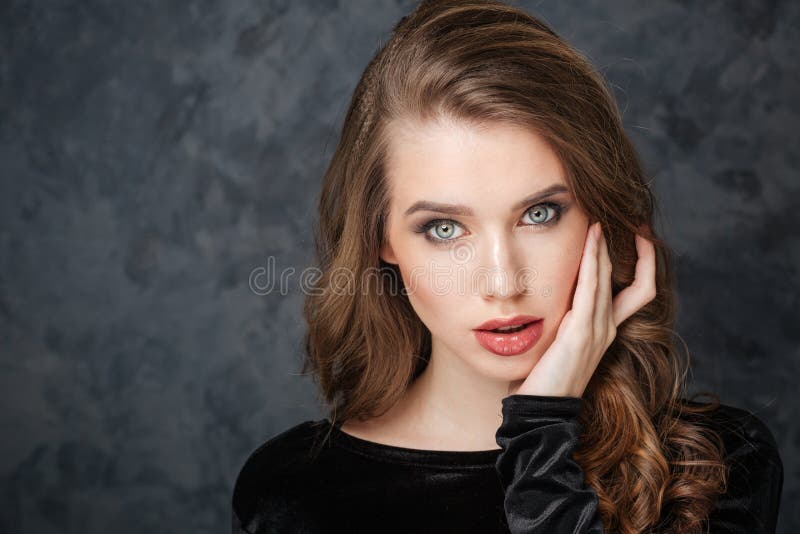 Charming gentle young woman touching sking on face by hand royalty free stock photo Charming gentle young woman touching sking on face by hand royalty free stock photo
