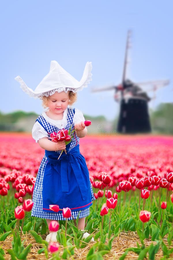 Charming Girl in Dutch Costume in Tulips Field with Windmill Stock ...