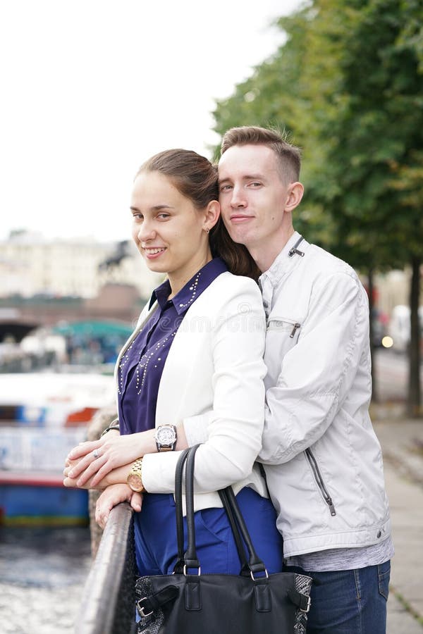 Charming Good Couple Husband And Wife Walking Around The City Hugging