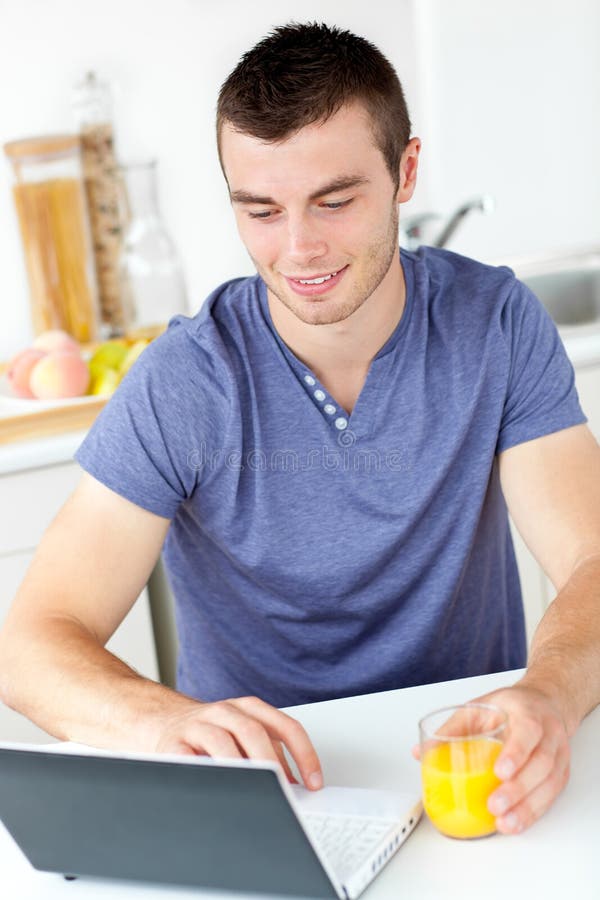Charming Man Using His Laptop Holding Orange Juice Stock Photo Image of charismatic,