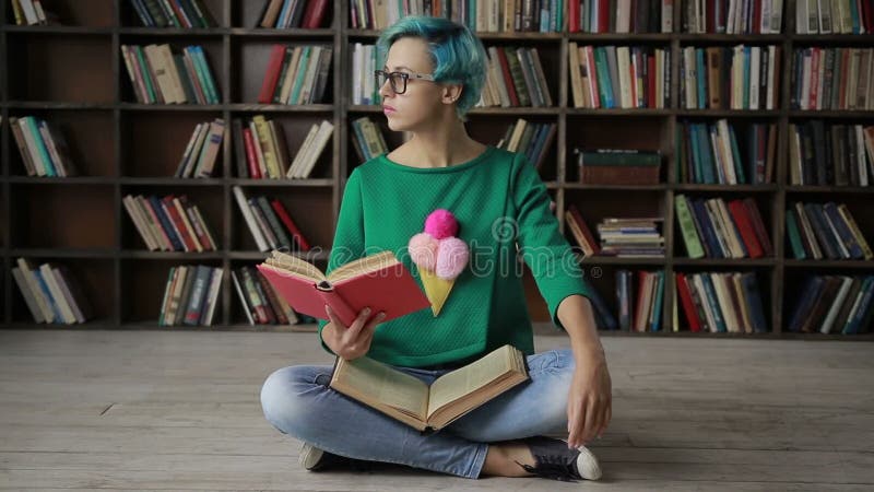 Young woman in glasses reading an interesting book