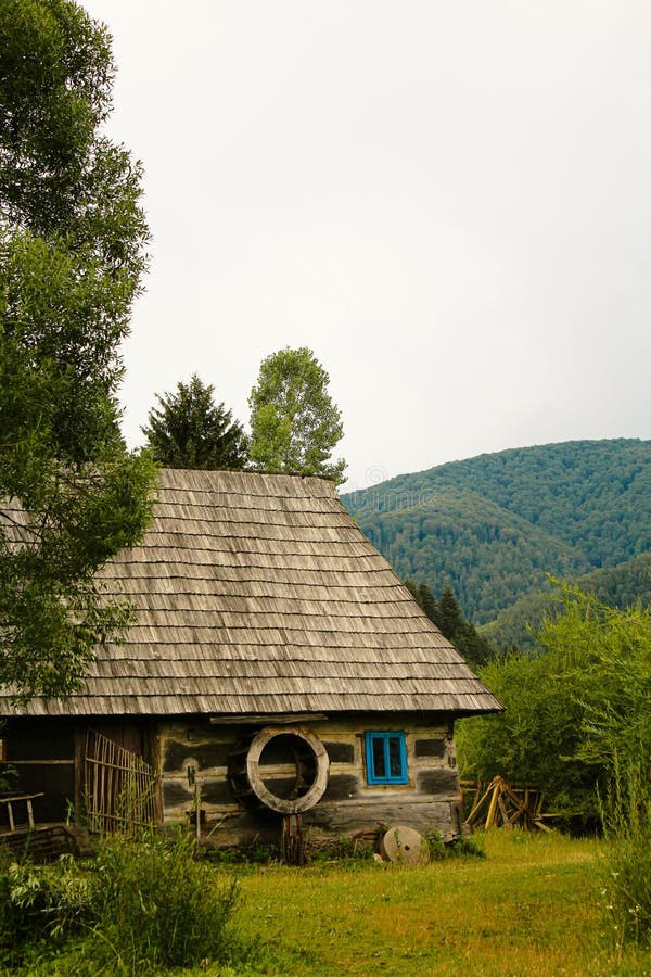 A charming small house featuring a blue window and a round window stock image