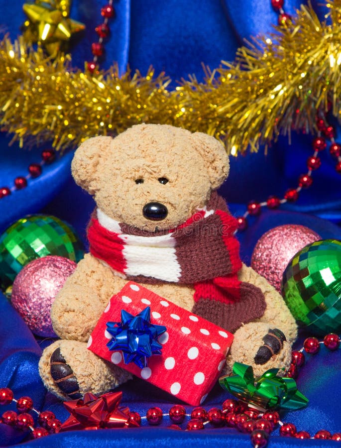 Charming small teddy bear with Christmas gift royalty free stock images