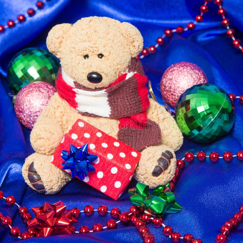 Charming small teddy bear with Christmas gift royalty free stock photography