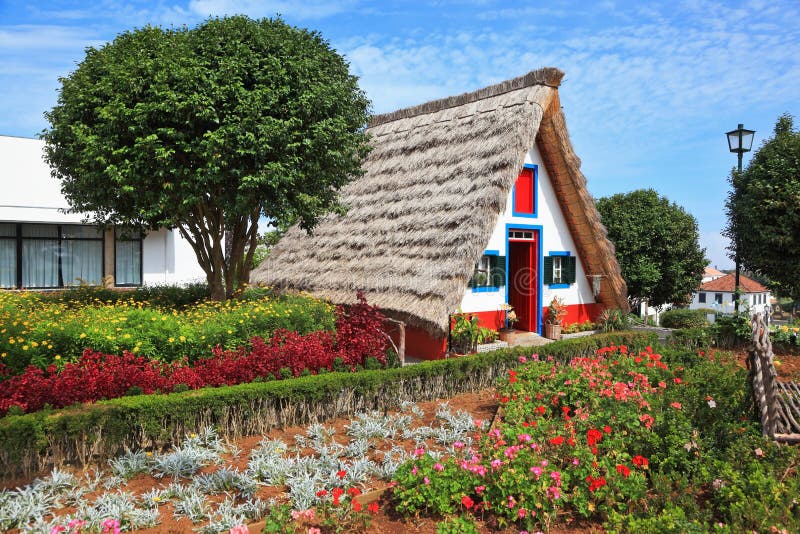 Charming white cottage with a thatched roof gable