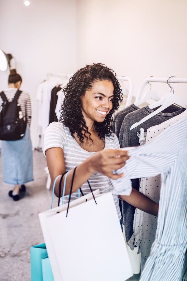 Charming Woman Exploring Hangers in Shop Stock Image - Image of ethnic ...