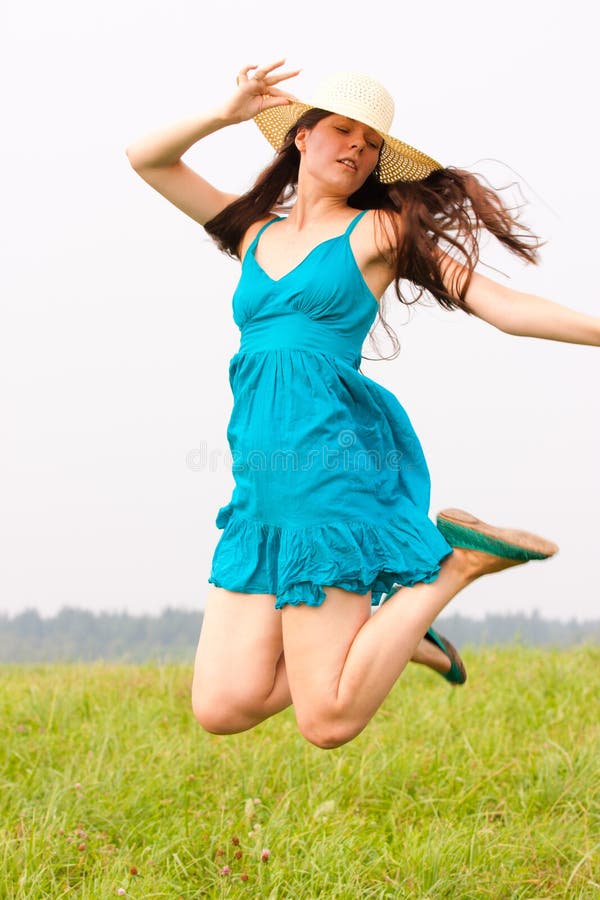 A charming woman jumps on nature