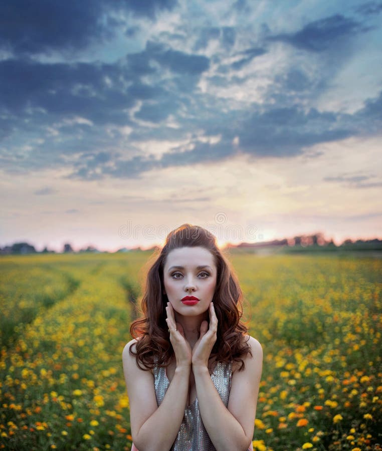 Charming woman among wild-flowers fields royalty free stock photo Charming woman among wild-flowers fields royalty free stock photo
