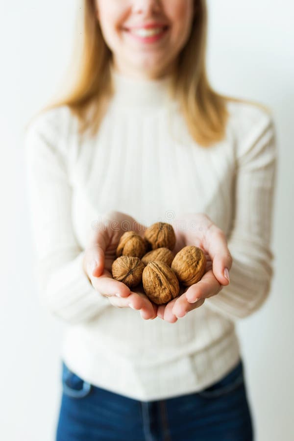Charming young woman hands holding almonds nuts on white background royalty free stock photos Charming young woman hands holding almonds nuts on white background royalty free stock photos