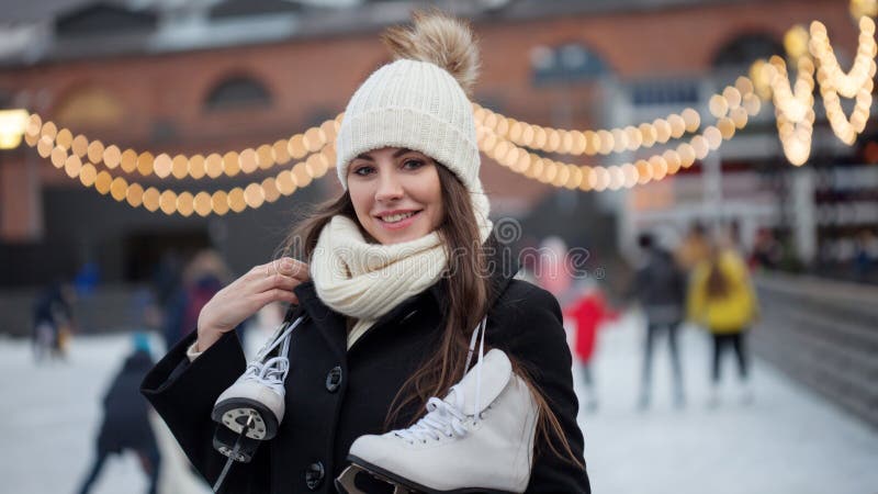 Charming young woman in the Park near the ice rink.