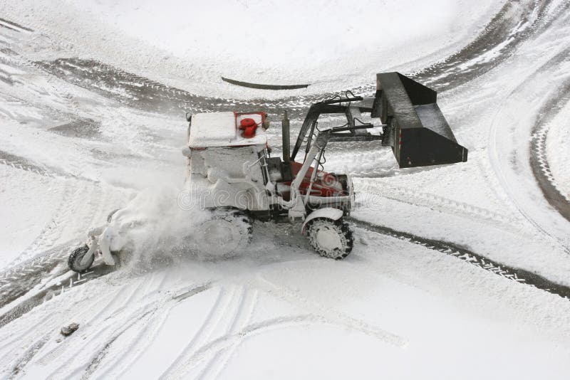 Snow Plow on small city road intersection. Snow Plow on small city road intersection