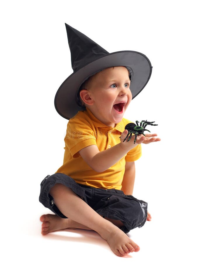 Spider hunting. Isolated image of black spider and small cute boy in witch hat. Spider hunting. Isolated image of black spider and small cute boy in witch hat