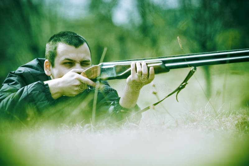 Chasseur visant avec un fusil de chasse photographie stock libre de droits