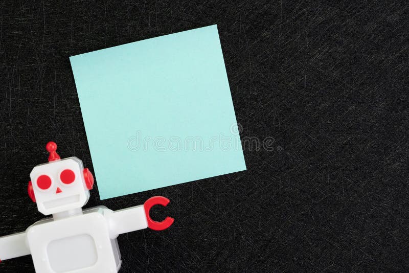 Chatbot, AI Artificial Intelligence concept, blue blank sticky note with vintage robot on dark black background with copy space to stock images Chatbot, AI Artificial Intelligence concept, blue blank sticky note with vintage robot on dark black background with copy space to stock images