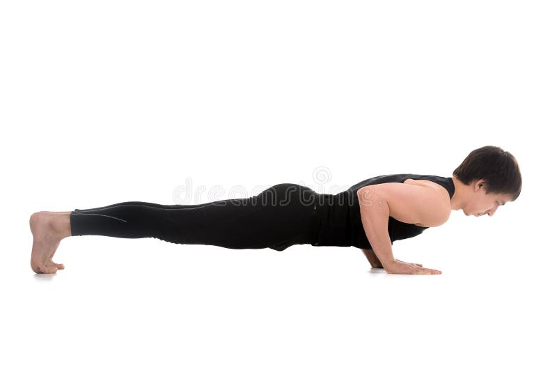 Woman yoga trainer doing a variation of Chaturanga Dandasana (four-limbed  staff) pose Stock Photo - Alamy