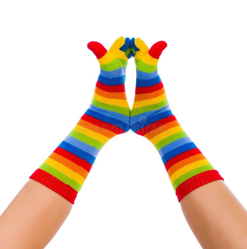 Striped socks on cold feet playing in the air. Striped socks on cold feet playing in the air.