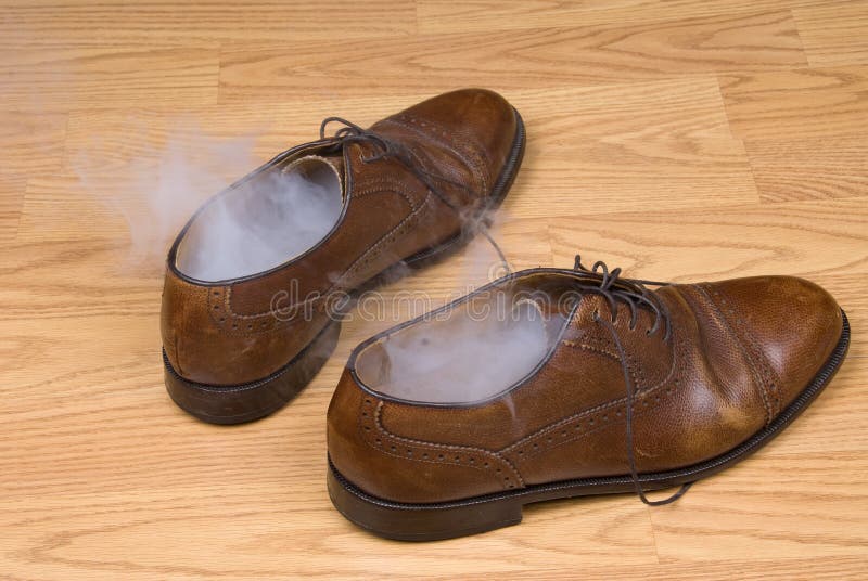 A pair of dress shoes steaming after a hot day of wear and tear. Image can also be used to infer someone has disappeared or vanished from their shoes. A pair of dress shoes steaming after a hot day of wear and tear. Image can also be used to infer someone has disappeared or vanished from their shoes.
