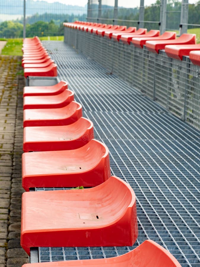 Cheap Red Stadium Seats View. Two Rows of Simple Chairs Stock Image