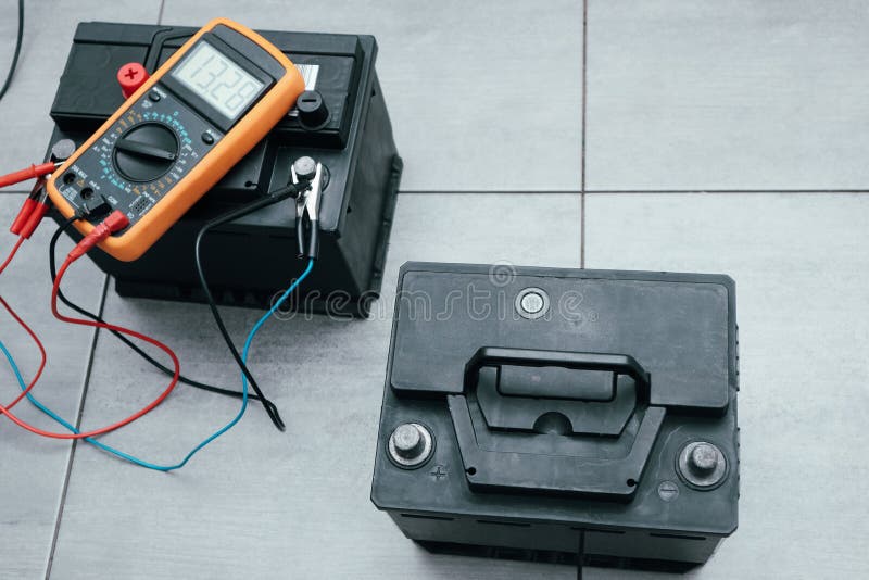 Check and Charge Car Battery with Charger. Auto Mechanic Measures