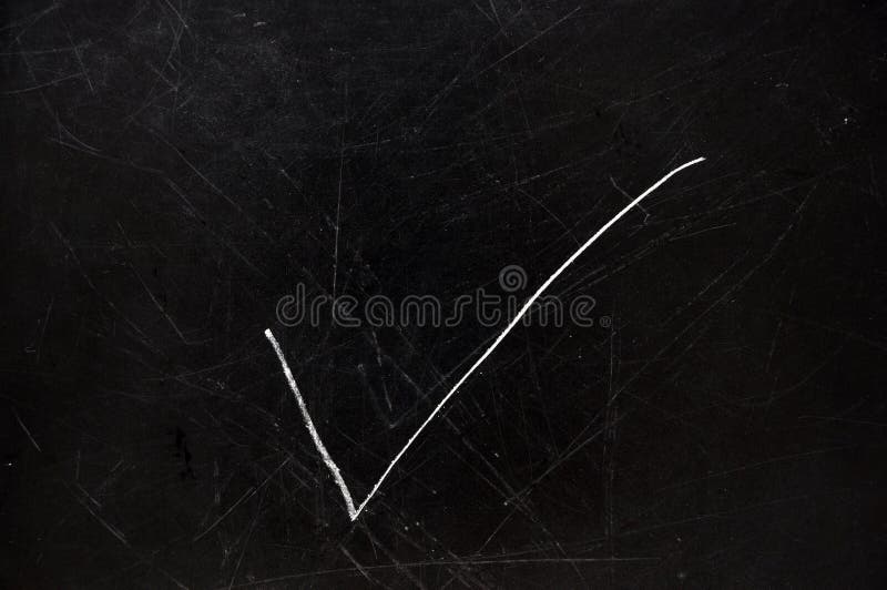 Checkmark on black chalkboard with copy space. Checkmark on black chalkboard with copy space.