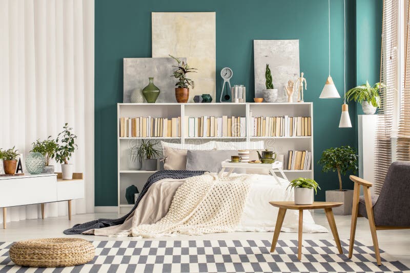 Checkered rug in stylish bedroom royalty free stock image