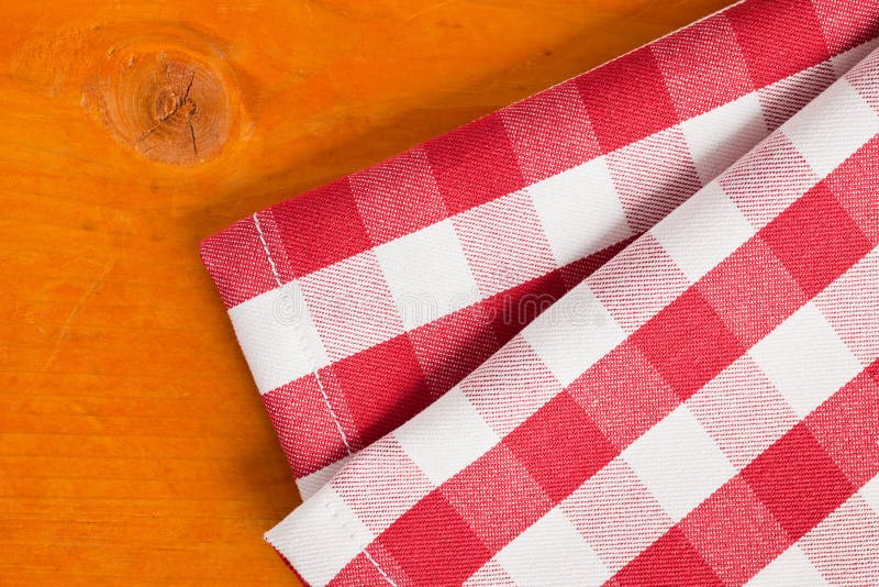 Photo shot of checkered napkin on wooden table. Photo shot of checkered napkin on wooden table