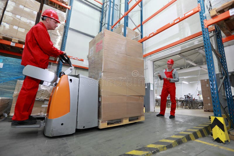 Two workers inside of industrial building - goods delivery. Two workers inside of industrial building - goods delivery